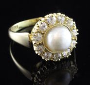 An 18ct gold, diamond and cultured pearl cluster ring, with central pearl bordered with eleven round