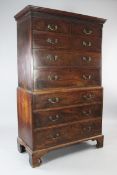 A George III mahogany chest on chest, with blind fret carved frieze over two short and three long