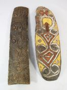 A Papua New Guinea Sepik River carved wooden shield, painted in white, ochre and red pigments and