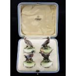 A set of four cold painted bronze menu holders, modelled as wildfowl and game birds, on circular