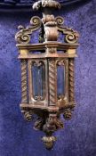 A large 19th century carved giltwood hanging lantern, with four glass sides, leaf carved barley