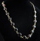 A Victorian graduated garnet fringe necklace, set with twenty six round cut stones, 15.5in.