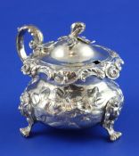 An early Victorian ornate silver mustard pot by Charles Gordon, of squat baluster form, with