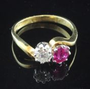 An 18ct gold, ruby and diamond set crossover ring, the round cut diamond weighing approximately 0.