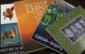 A collection of approximately sixteen Chinese reference books, including "The Thistle and the Jade,"
