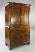 A mid 18th century walnut and featherbanded linen press, fitted two doors above two short and
