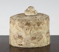 A Japanese ivory tusk box and cover, Meiji period, carved with lion and tiger masks and with tiger's