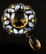 An early 20th century silver and gem set brooch in the manner of Sibyl Dunlop, of circular open work