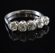 An 18ct white gold and graduated five stone diamond half hoop ring, set with old mine cut stones,