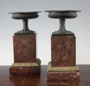 A pair of gadrooned bronze urns, on square rouge marble pedestals, with ormolu mounts, 9.5in.