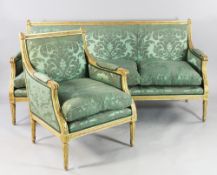 A Louis XVI style carved giltwood three piece salon suite, upholstered in a green damask fabric with
