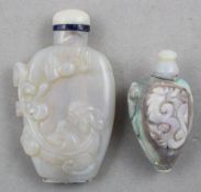 Two Chinese opal snuff bottles, 1880-1940, the first of flattened baluster form, carved in high