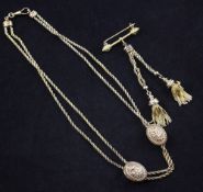 A gold double strand rope twist necklace with two sliding three colour gold oval foliate panels,