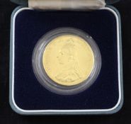 A Victoria 1887 £5 gold coin.