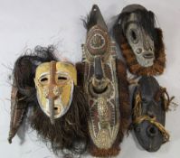 A Papua New Guinea Sepik River carved wooden mask, of zoomorphic form, painted in yellow ochre,