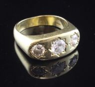 A gentleman's 18ct gold and gypsy set three stone diamond ring, the graduated stones with an