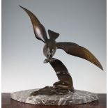 A French Art Deco patinated bronze model of a sea bird on the crest of a wave, stamped 'Bronze',