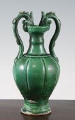 A Chinese green glazed pottery twin handled vase, in Tang style, with dragon head handles and a
