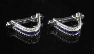 A pair of French 18ct white gold and sapphire cufflinks, of loop form, with channel set sapphires