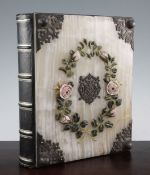 A Victorian morocco bound photograph album, the front with silver mounted onyx cover, with central