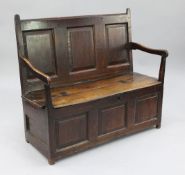 An 18th century oak box seat settle, with open arms and fielded panels, W.3ft 9in.