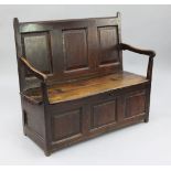 An 18th century oak box seat settle, with open arms and fielded panels, W.3ft 9in.
