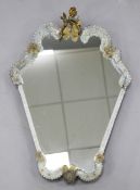 A Venetian style cartouche shaped wall mirror, the frame with opalescent glass scrolling panels with