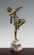 A French Art Deco patinated and cold painted metal figure of a dancing girl, standing on one leg, on