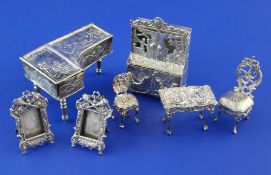 A small group of late 19th/early 20th century continental and English embossed silver miniature