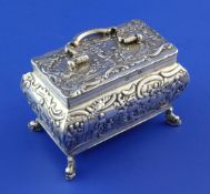 A late 19th century Dutch silver bombe shaped casket, with hinged lid and handle, embossed with