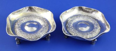 A pair of early 20th century Chinese silver shallow dishes, of hexafoil shape, embossed with band of