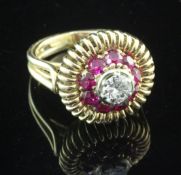 A 1960's? continental gold, diamond and synthetic ruby target dress ring, with pierced setting,