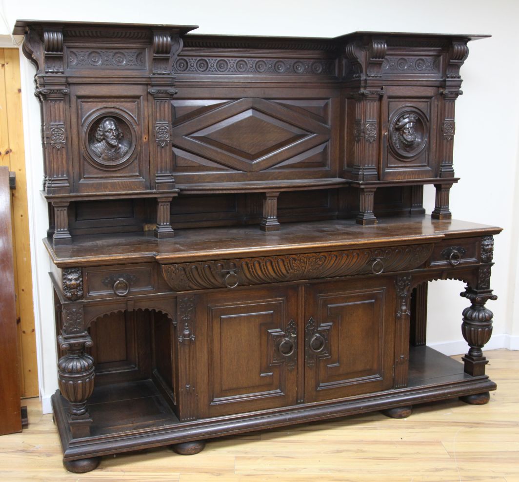 A late 19th century large carved oak breakfront sideboard, the back with central open shelf