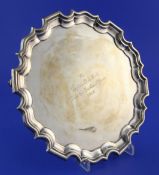 A George V Irish silver salver, of circular form, with pie crust border and engraved inscription, on