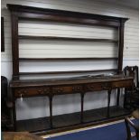 A large 18th century oak Welsh dresser, with open plate rack between reeded sides above four