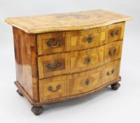 An 18th century German marquetry inlaid walnut serpentine commode, with three long drawers, on