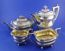 A George III demi-fluted silver four piece tea and coffee set by J.W. Story & William Elliot, of
