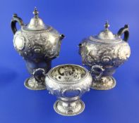A late Victorian repousse silver part three piece tea and coffee set by Mappin Brothers, of inverted