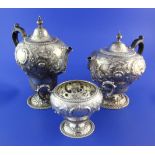 A late Victorian repousse silver part three piece tea and coffee set by Mappin Brothers, of inverted