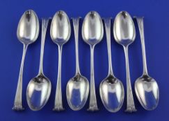 A matched set of eight 18th century silver Onslow pattern dessert spoons, most with indistinct