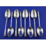 A matched set of eight 18th century silver Onslow pattern dessert spoons, most with indistinct