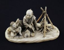 A Japanese ivory okimono, Meiji period, depicting a seated man and a boy holding chopsticks by a
