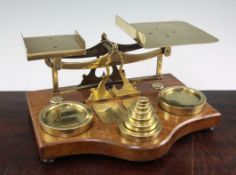 A set of Victorian brass and oak postal scales, fitted with two 4lb circular brass weights and other