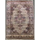 A Tabriz rug, with field of scrolling foliage on a pink and ivory ground, with multi row border, 9ft