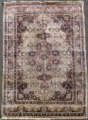 A Tabriz rug, with field of scrolling foliage on a pink and ivory ground, with multi row border, 9ft