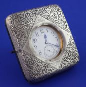 An Edwardian silver mounted travelling watch case, containing a nickel cased pocket watch with