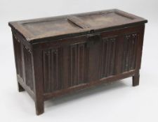 An 18th century oak coffer, the front with linenfold carved panels, on stile feet, W.3ft 6in.