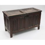 An 18th century oak coffer, the front with linenfold carved panels, on stile feet, W.3ft 6in.