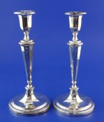 A pair of Edwardian silver candlesticks, with tapering octagonal stems, Thomas Levesley,