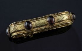 A late 19th/early 20th century gold and garnet snake link bracelet, set with six oval cabochon